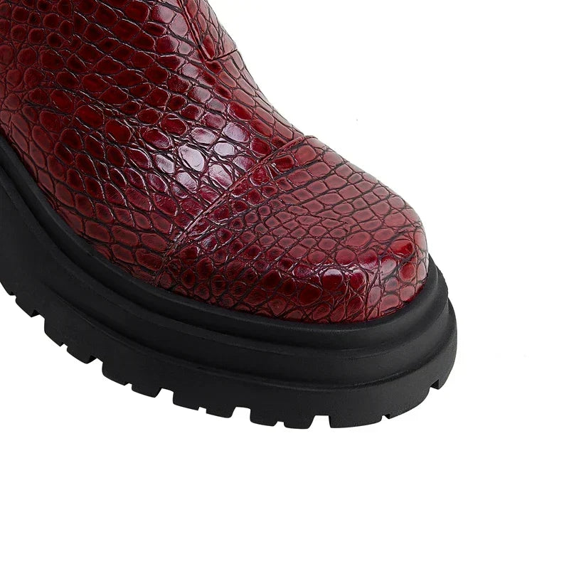 Women's faux leather Chelsea boots styled on foot