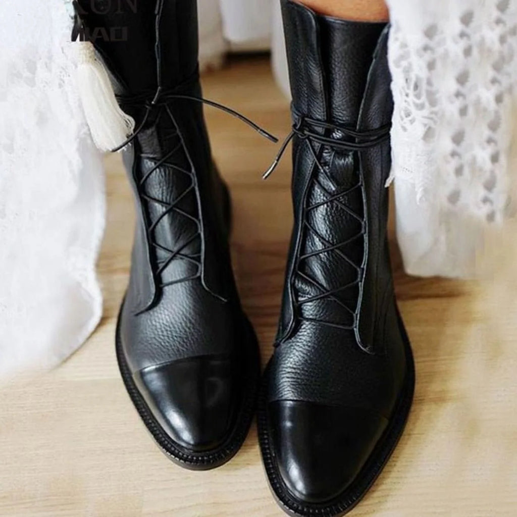 Close-up of the patent cap toe on the women's lace-up boots