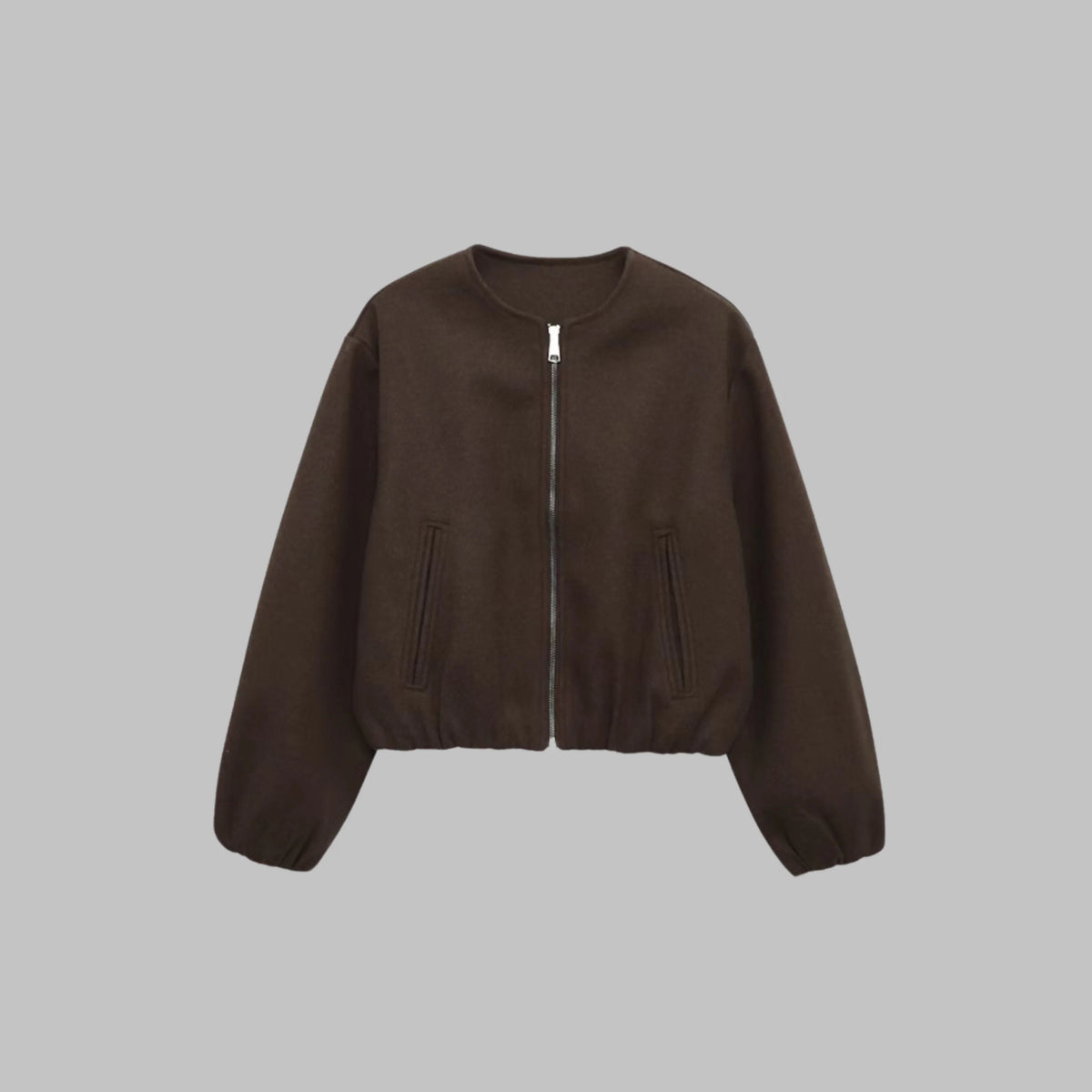 Women's collarless cropped jacket in brown, close-up of elastic hem