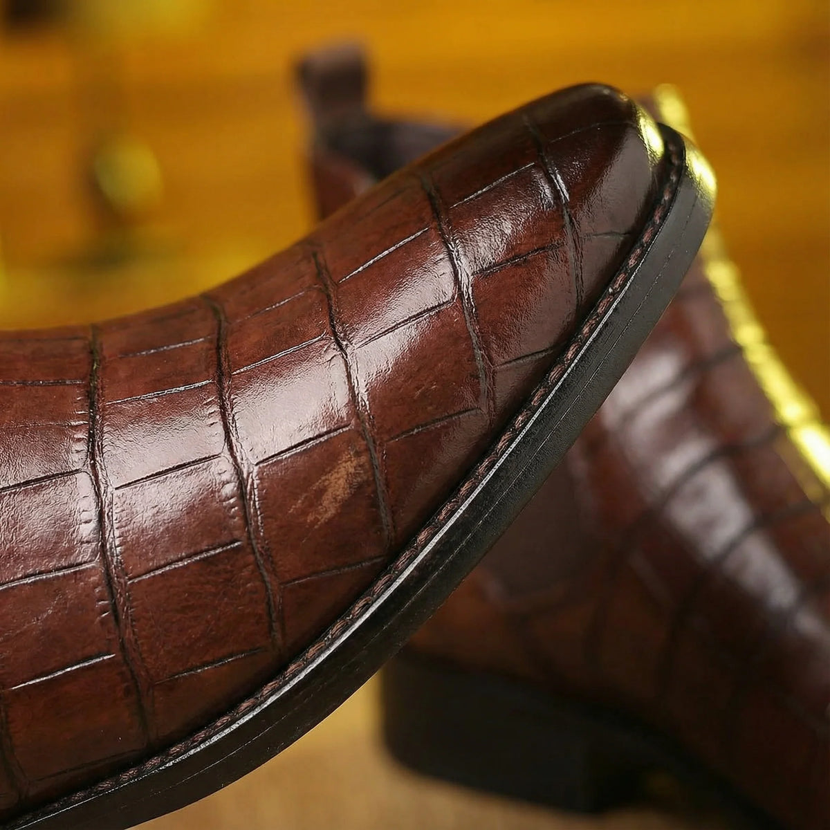 Close-up of the pointed toe on the maroon Chelsea boots