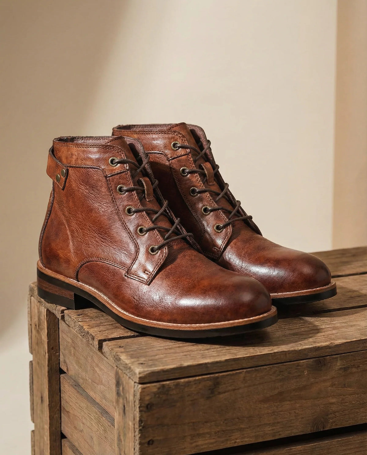 Close-up of the brass-eyelet lacing on the brown work boots